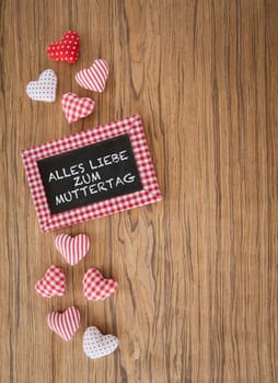 Small panel with colorful hearts on a wooden background