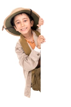 Young boy with Safari clothes behind a white board isolated in white