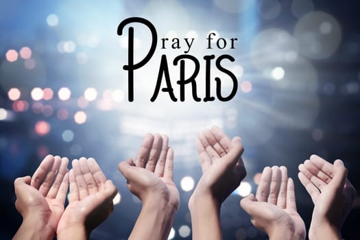 Human hand pray for paris incident, with blur city background