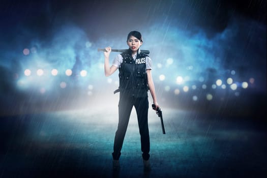 Pretty woman in police vest holding baseball bat as weapon