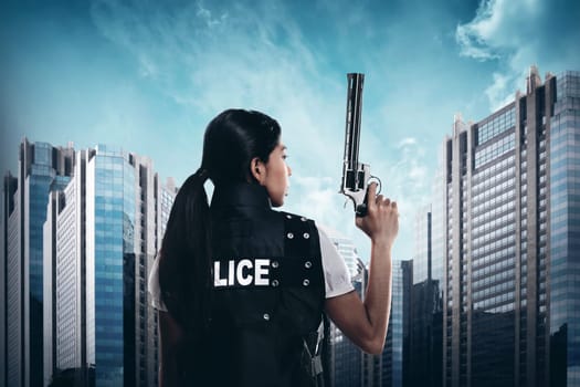 Beautiful police woman holding gun ready to fire