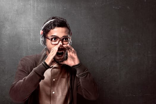 Asian man wearing headphone and shouting with mouth