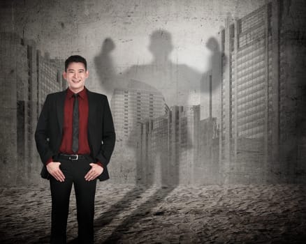 Asian business man casting a shadow of strength. Career concept