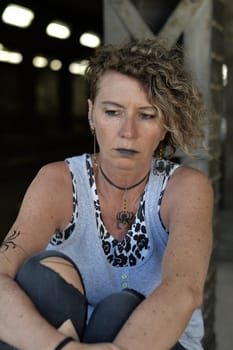 Middle-aged punk stares gloomy at herself