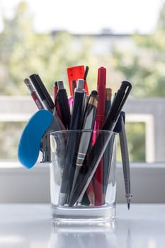 work desk with stationery in glass light background
