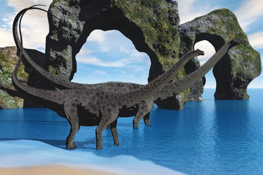 Two Diplodocus dinosaurs wade in shallow waters along a coastline.