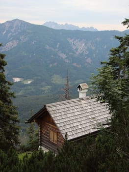 Small Hiking Rest House on Cliff Overhang with View of Forest Mountains