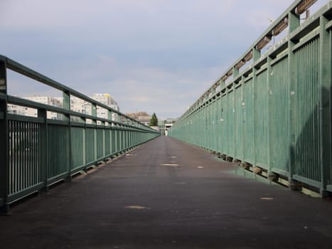 Very long Asphalt Footpath with Green Metal Banisters Perspective