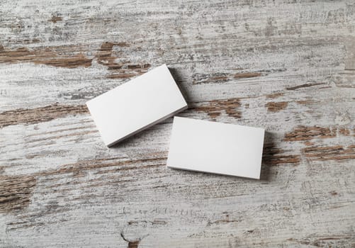 Photo of blank business cards on wood background. Template for ID. Top view.