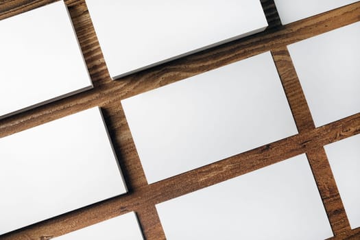 Many blank business cards on wooden background. Mockup for ID. Top view.