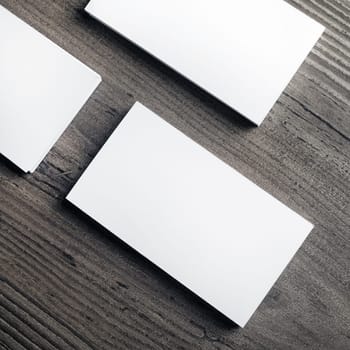 Blank business cards on wood table background. Template for ID. Top view.