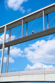 Man on a bridge between two government buildings in the government district of Berlin