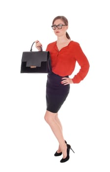 A gorgeous young business woman standing in a red blouse and black .skirt, holding her black purse with glasses isolated for white background.