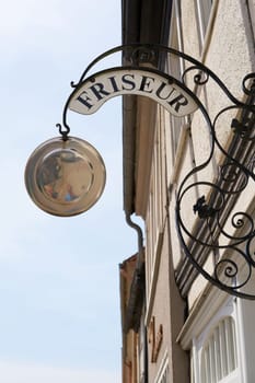 Guild sign for a hairdresser in the old town of Tangermünde in Germany