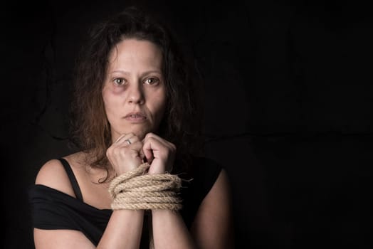Abused woman victim of domestic violence tied with rope