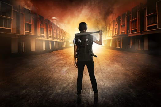 Pretty woman in police vest holding baseball bat as weapon
