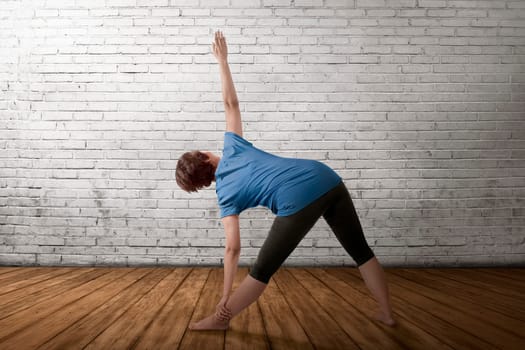Asian pregnant mother doing yoga in empty room, she was swinging her arms upwards