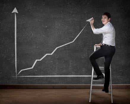Asian business person drawing chart on the board
