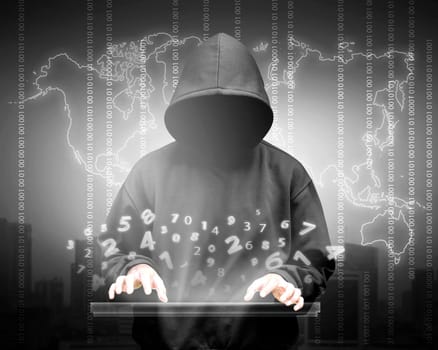 Computer hacker silhouette of hooded man with binary data and network security terms