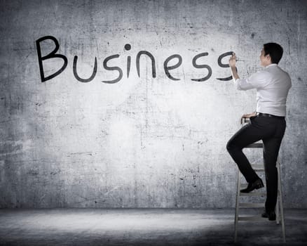 Asian business person drawing business on the board