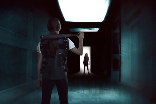Young woman holding a baseball bat standing in a dark hallway with zombie on the entrance door