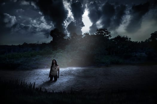 Spooky zombie standing on the creepy lake. Halloween concept