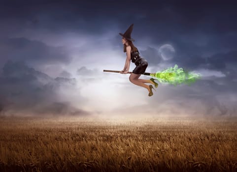 Asian witch using broom flying over meadow field