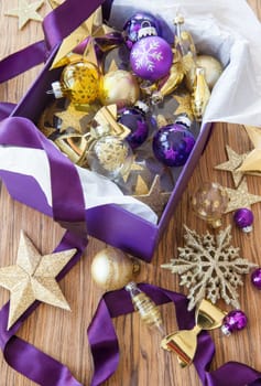 Colorful decoration in purple box on rustic wood