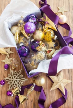 Colorful decoration in purple box on rustic wood