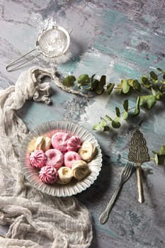 The pink cookies on wooden table background