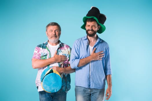 The two football fans singing the national anthem over blue background