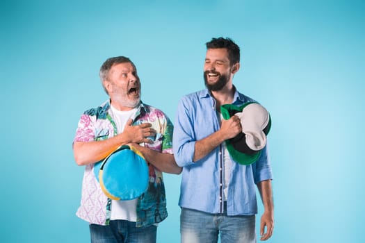 The two football fans singing the national anthem over blue background
