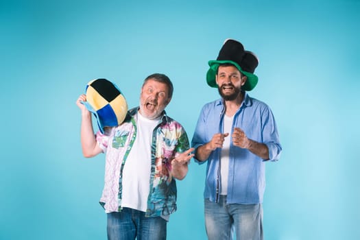 The two emotional football fans over blue background