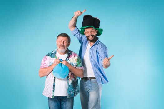 The two emotional football fans over blue background
