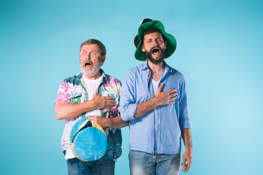 The two football fans singing the national anthem over blue background
