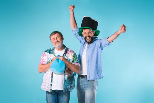 The two emotional football fans over blue background