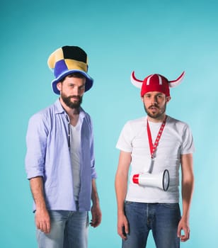The two football fans with emotions of disappointment over blue background