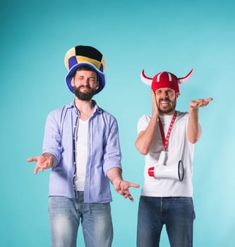 The two football fans with emotions of disappointment over blue background