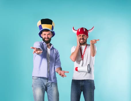 The two football fans with emotions of disappointment over blue background
