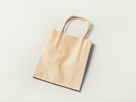 Paper shopping bag on paper background. Craft paper package.