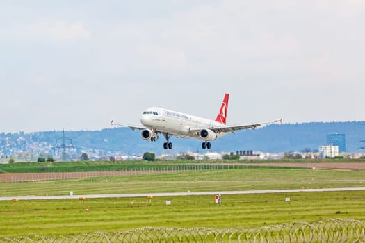 Stuttgart, Germany - April 29, 2017: Airbus airplane A321 from Turkish Airlines on landing approach at airport Stuttgart - runway and green meadow in front