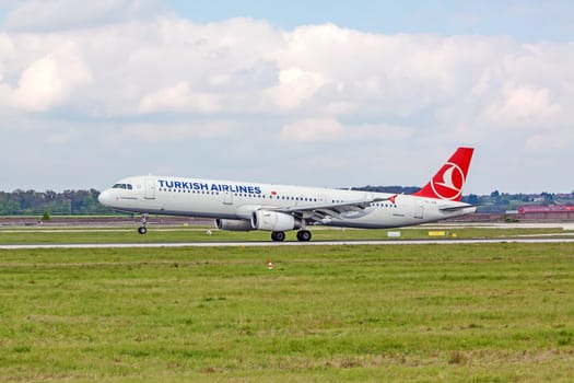 Stuttgart, Germany - April 29, 2017: Airbus airplane A321 from Turkish Airlines on landing approach at airport Stuttgart - runway and green meadow in front