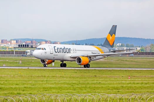 Stuttgart, Germany - April 29, 2017: Airbus airplane A320 from Condor at ground (airport Stuttgart) before takeoff - green meadow with fence in front