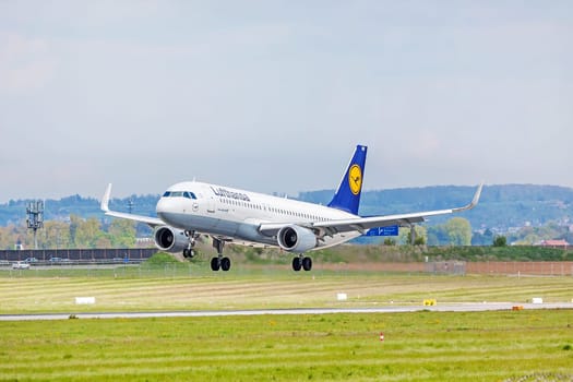 Stuttgart, Germany - April 29, 2017: Airbus airplane A320 200 from Lufthansa on landing approach to airport Stuttgart - runway and green meadow in front
