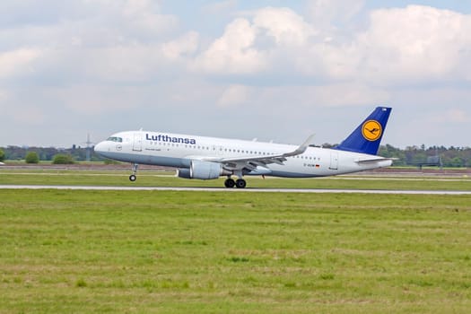 Stuttgart, Germany - April 29, 2017: Airbus airplane A320 200 from Lufthansa on landing approach at airport Stuttgart - runway and green meadow in front