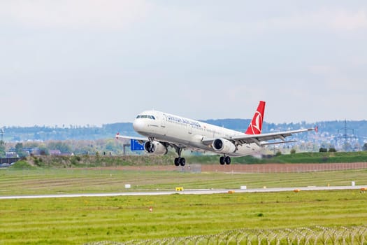 Stuttgart, Germany - April 29, 2017: Airbus airplane A321 from Turkish Airlines on landing approach at airport Stuttgart - runway and green meadow in front
