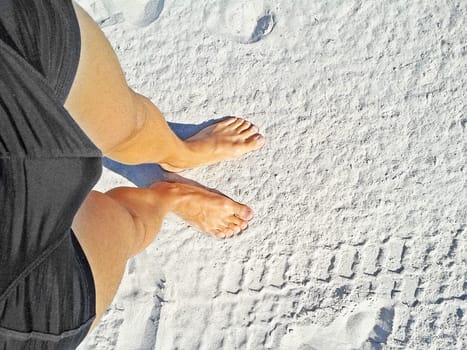 two feet on the beach / sand top view
