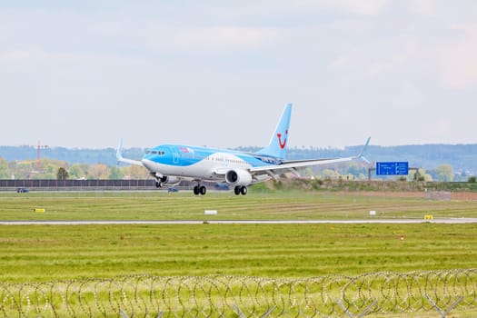 Stuttgart, Germany - April 29, 2017: Airbus airplane A320 from TUIfly on landing approach to airport Stuttgart - green meadow with weather station in front