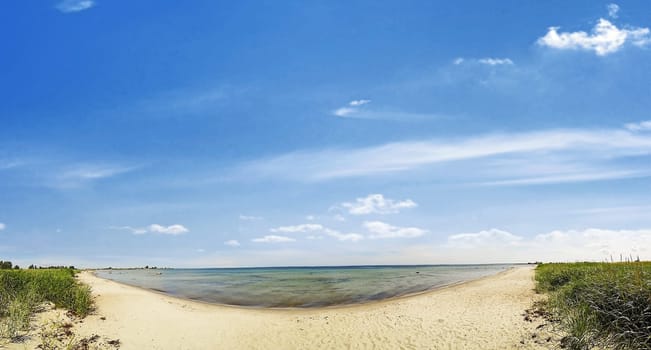 beach panorama - sand and ocean with blue sky