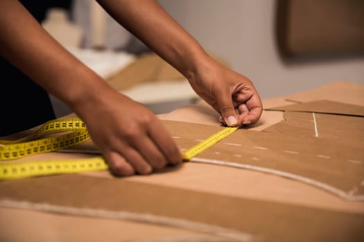 Portrait of a young fashion designer working on her atelier